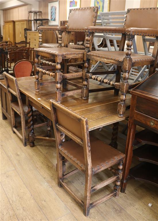 A 1920s oak draw-leaf table and six leather seat dining chairs, 152cm fully extended